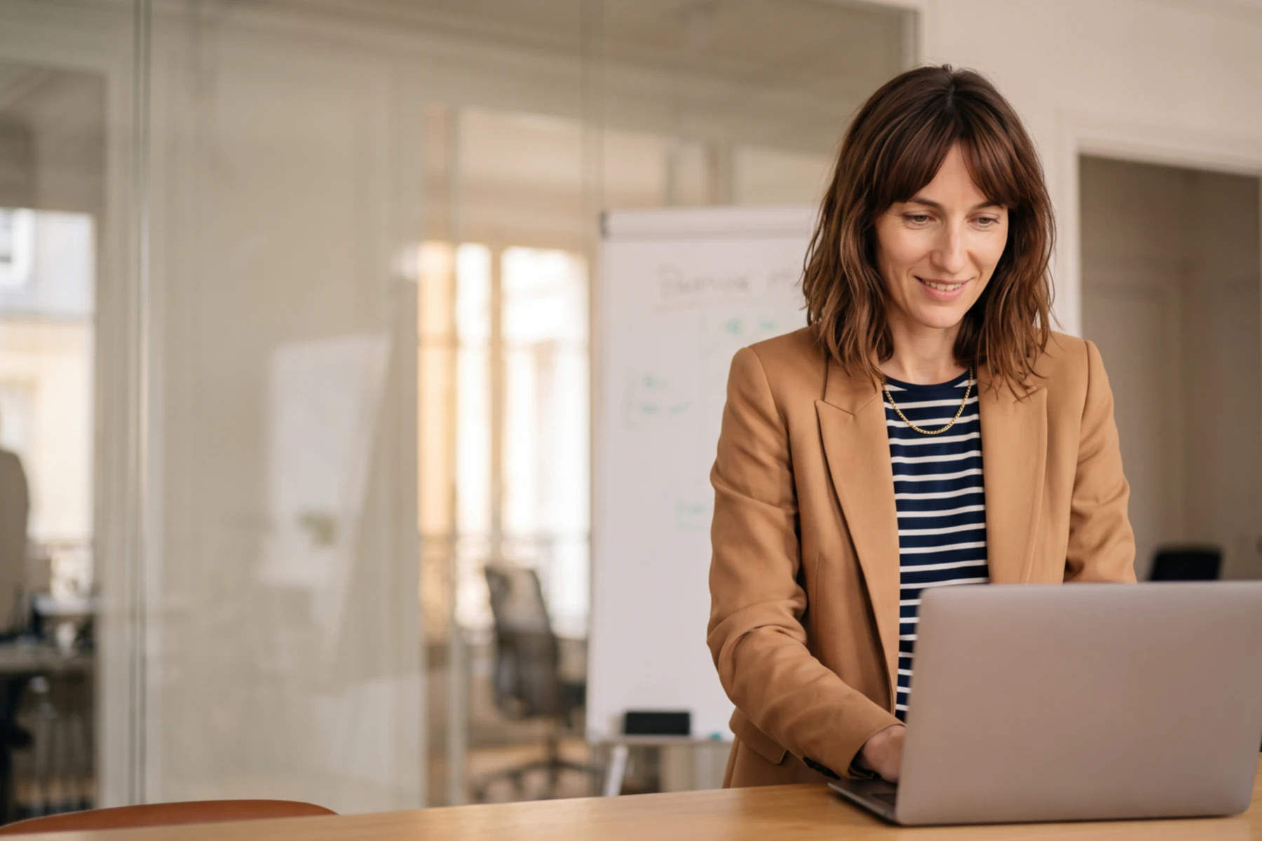 Aurélie Trudeau, marketing director, reading her laptop in a meeting room.